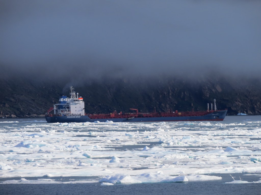 A tanker of fuel in Pangnirtung Fiord, skirting ice